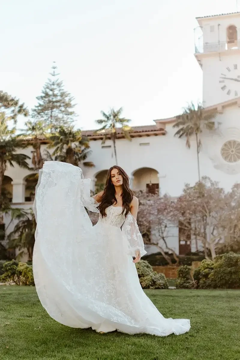 model is wearing a strapless bridal gown with detachable long sleeves