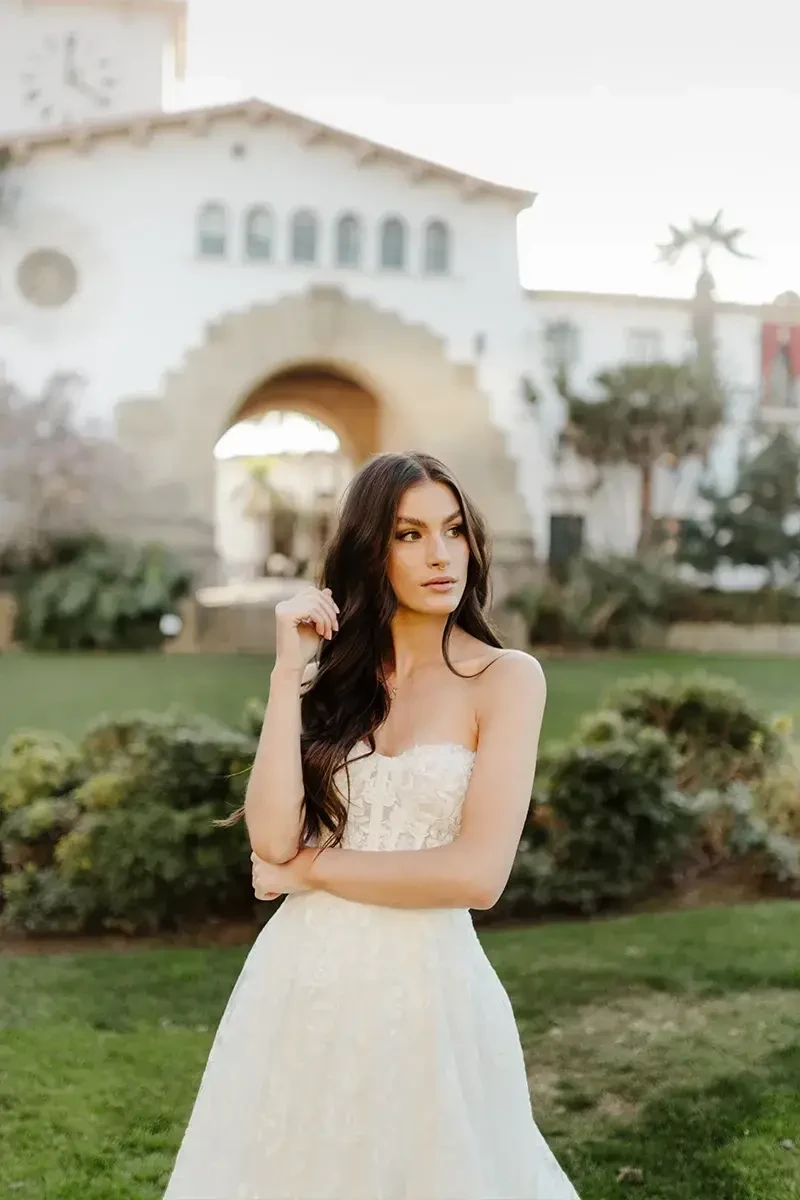 model is wearing a strapless bridal gown with detachable long sleeves