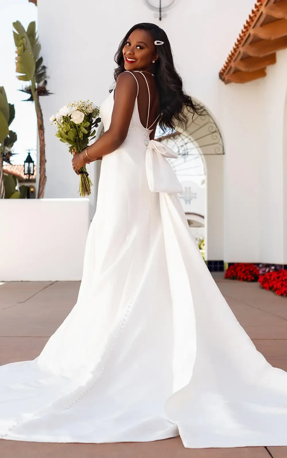 model is wearing a sleeveless mikado bridal gown