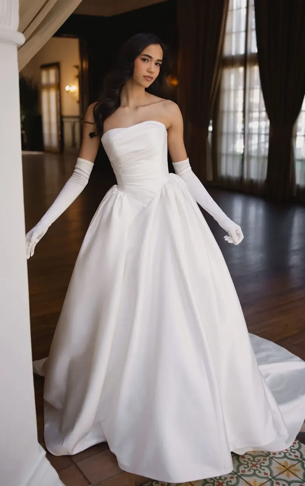 model is wearing a strapless satin ball gown