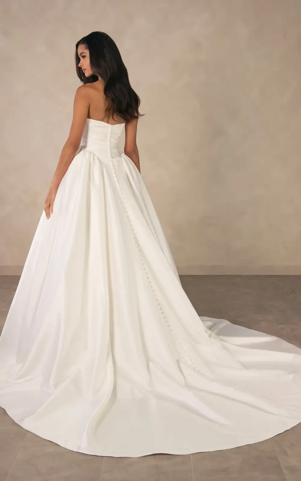 model is wearing a strapless satin ball gown
