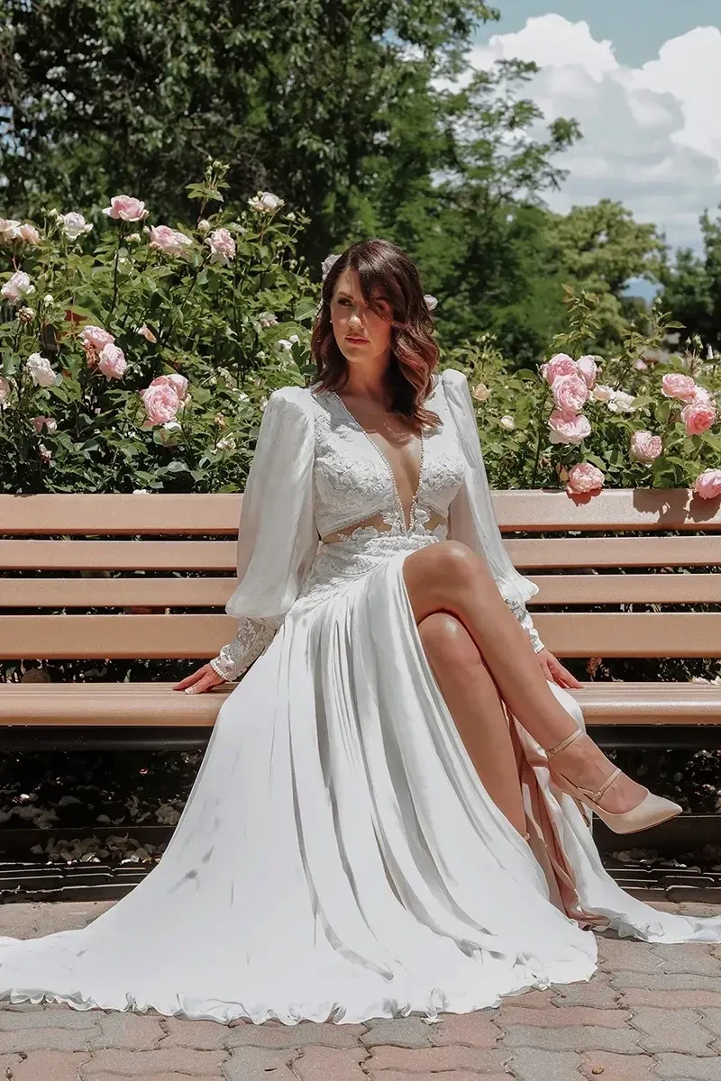 model is wearing a bohemian wedding dress with blouson sleeves