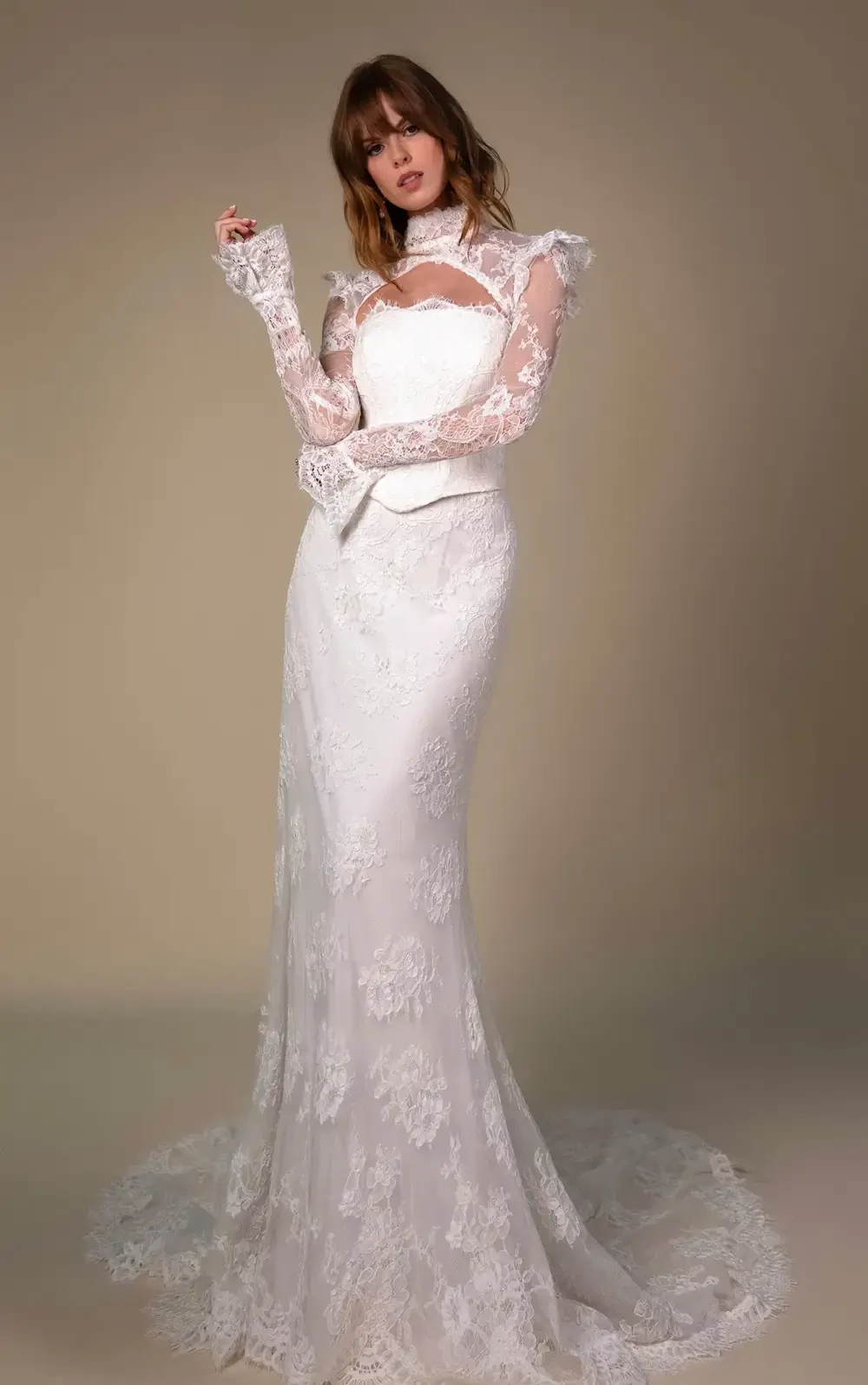 model is wearing a long sleeve lace bridal gown