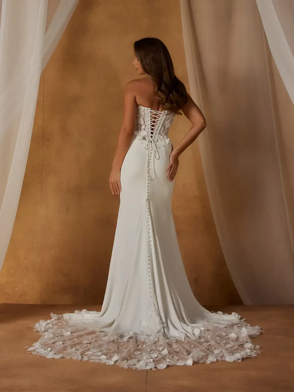 model is wearing a fit and flare 3d floral applique bridal gown