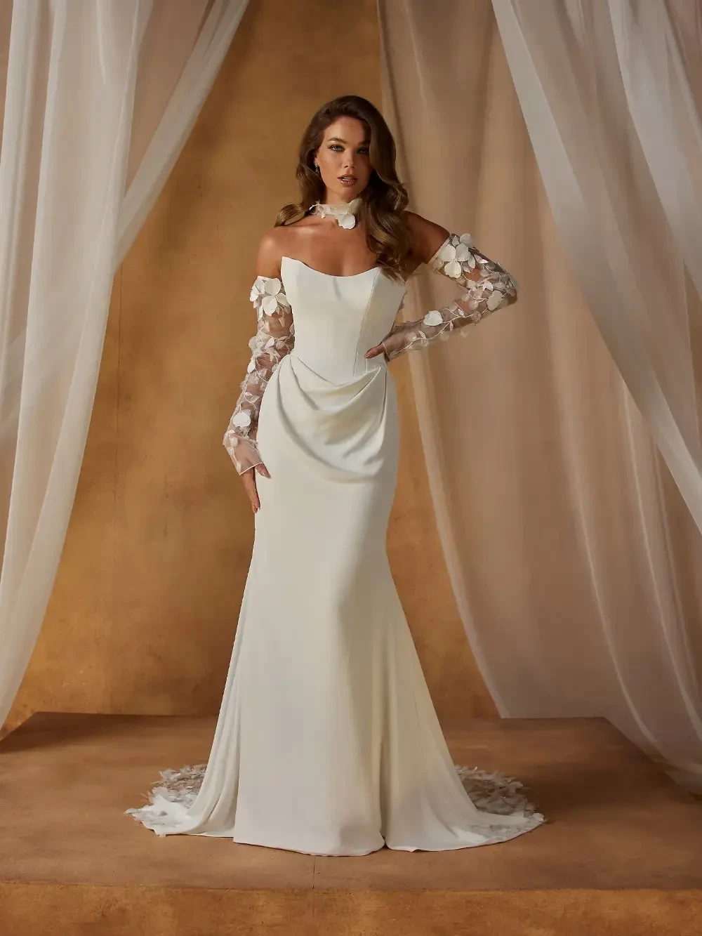 model is wearing a fit and flare 3d floral applique bridal gown