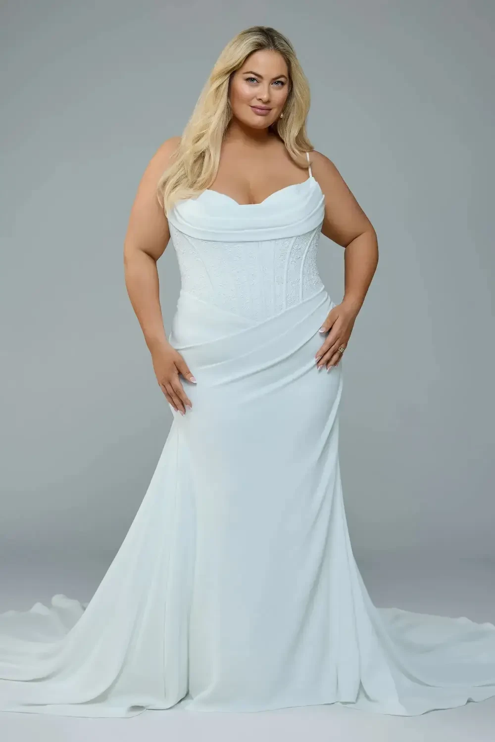 model is wearing a plus size spaghetti strap bridal gown